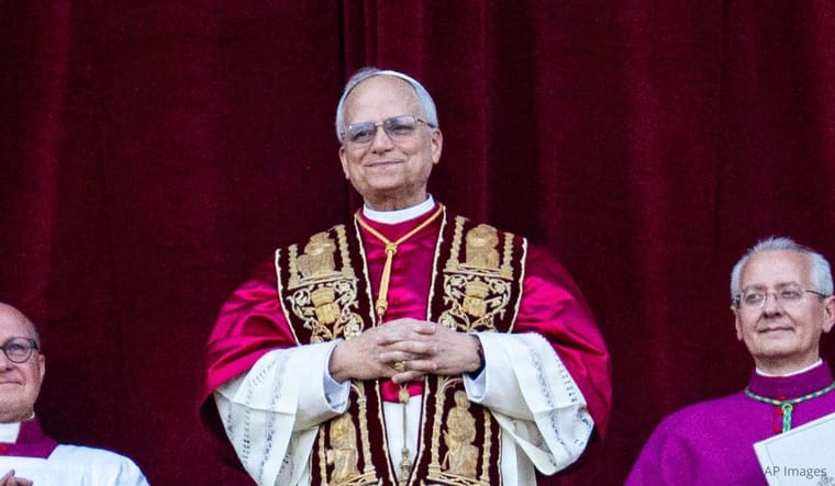 Newly elected Pope Leo XIV, Robert Prevost, arrives on the main central loggia balcony of St. Peter's Basilica for the first time on May 8, 2025. (Photo by Massimo Valicchia/NurPhoto via AP).